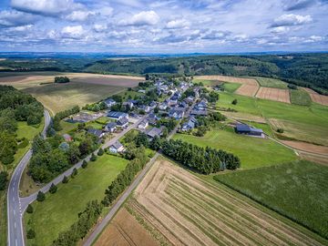 The picture is taken from a bird's eye view. The picture shows the small Hunsrück village of Moritzheim. 