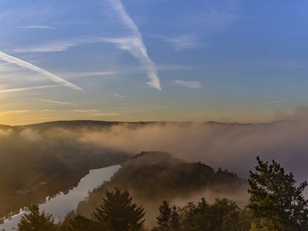 View The picture shows the view from the Prinzenkopfturm in foggy weather. The sun is in the sky on the left.