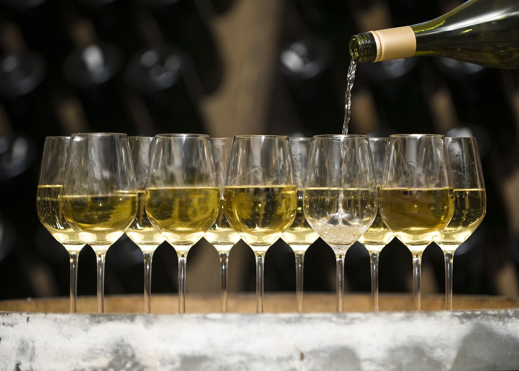 Wine The picture shows several wine glasses being filled with wine.