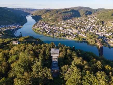 Prinzenkopfturm Surrounded by trees is the Prinzenkopfturm observation tower. Behind it is the Moselle, which is crossed by the double-decker bridge. In the background is the village of Bullay and on the left the village of Alf.